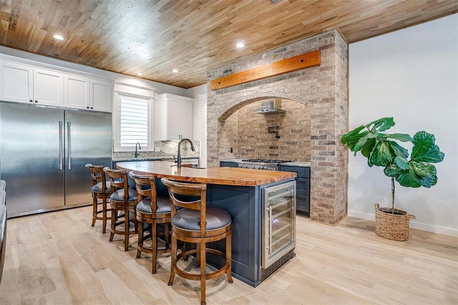 A built-in wine fridge offers convenience and style, making this space perfect for entertaining and culinary creations alike.