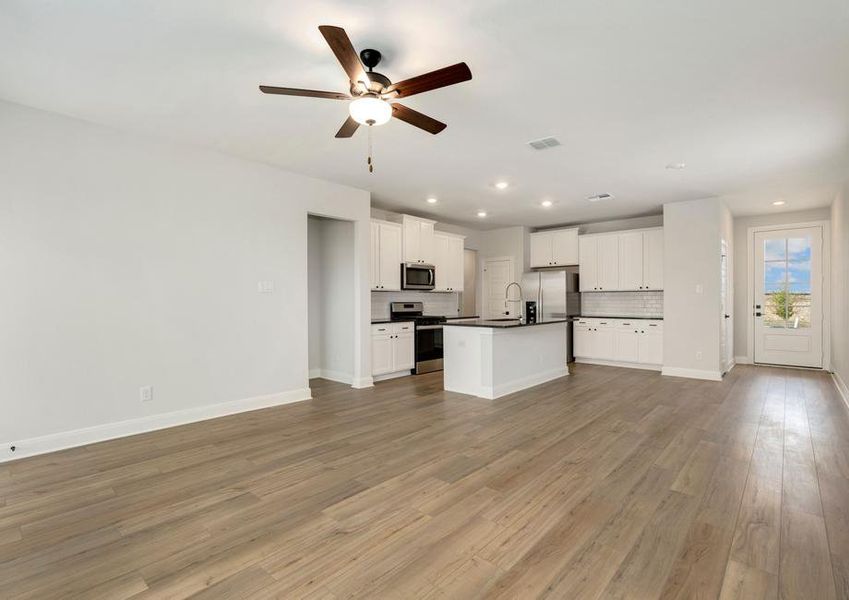 Open-concept layout with the kitchen overlooking the dining area and living room.