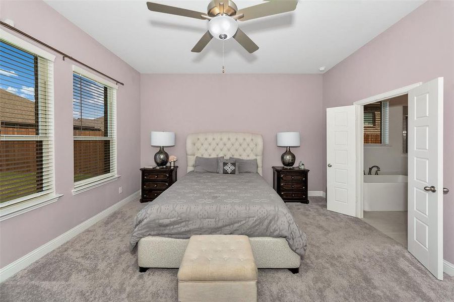 Bedroom with light colored carpet and ceiling fan