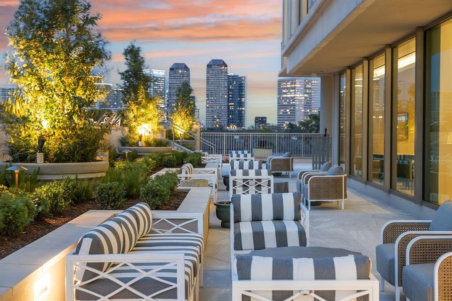 Outdoor seating flanked by manicured landscaping welcomes you to take in dramatic views from Post Oak high-rises to dazzling sunsets.