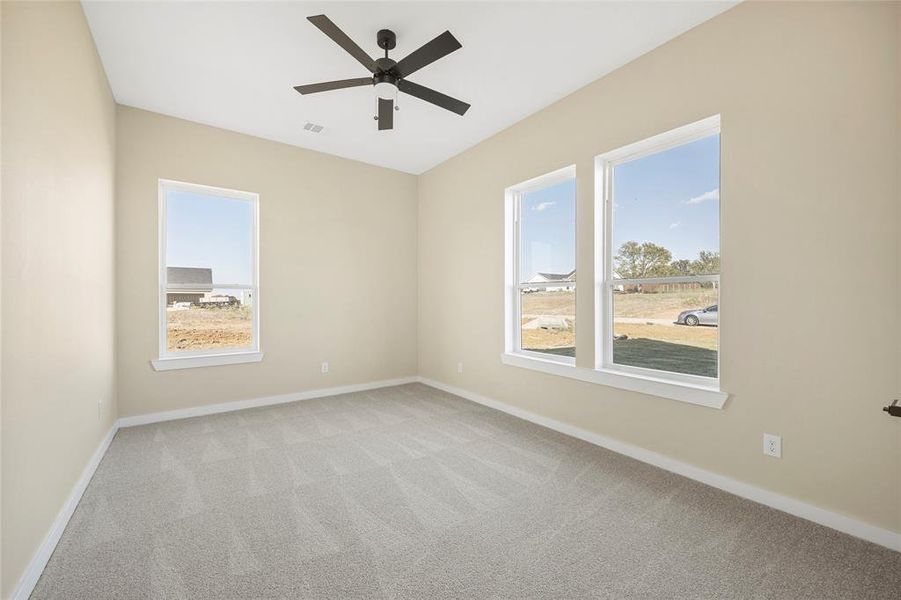 Spare room with light colored carpet and ceiling fan