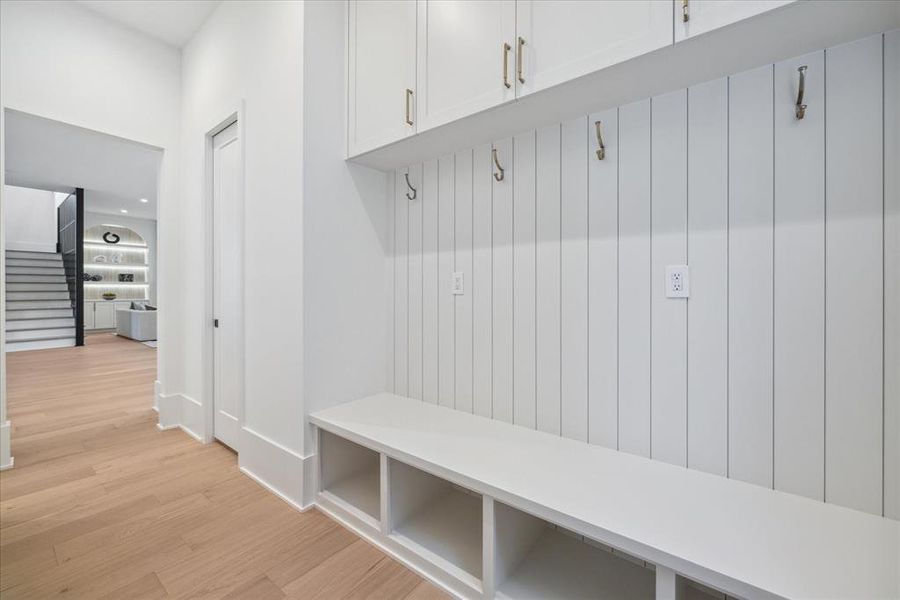 MUDROOM: Custom-built cubbies and cabinets provide ample space to stow away coats, shoes, and outdoor gear, keeping clutter at bay and maintaining a sense of order in the home.