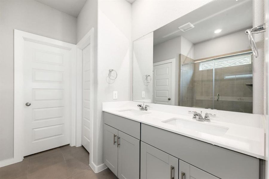 This primary bathroom is definitely move-in ready! Featuring a spa-like oversized walk-in shower with tile surround, Quartz countertops, spacious walk-in closet with shelving, high ceilings, neutral paint, sleek and modern finishes.