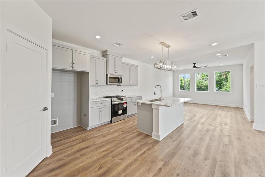 Heading Upstairs Your Greeted By The Stunning Kitchen With A Spacious Island, Gas Range Stove & Dishwasher.