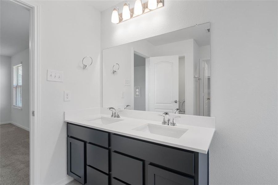 This large primary bath is spacious enough to share! With separate vanities, large closet space, plentiful cabinet and counter space, you are sure to have private area while sharing this bathroom!