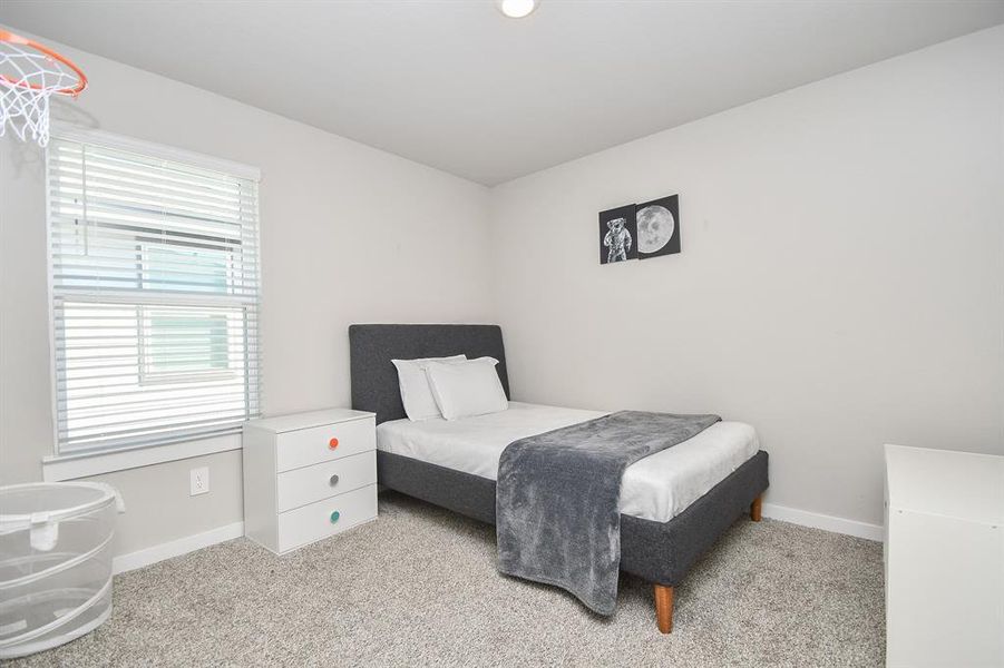 Bedroom with a bed, nightstand, and decor in neutral tones.