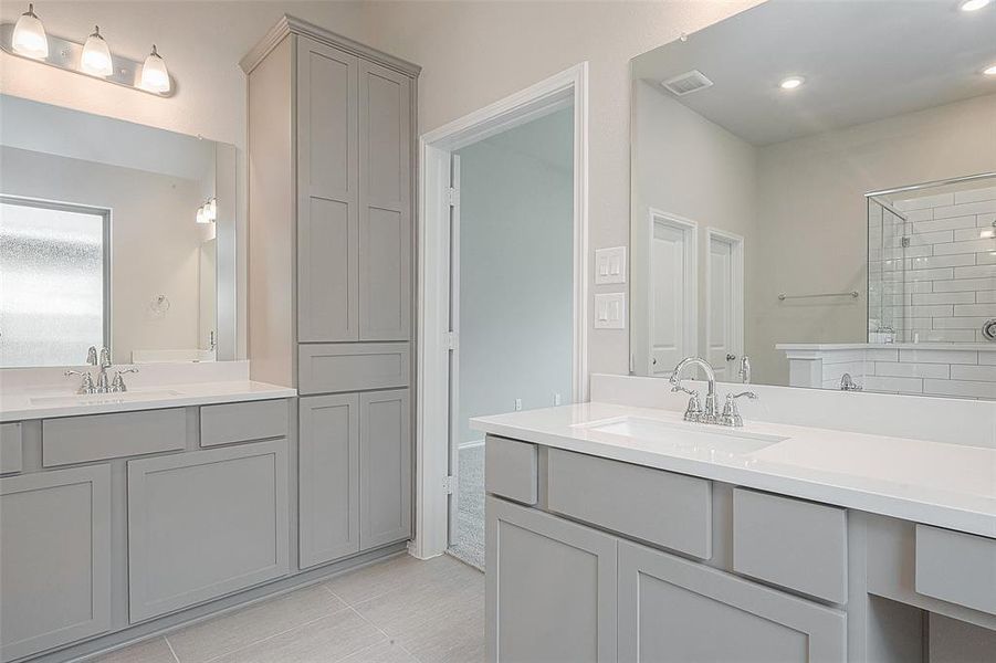 Bright double vanity with wall to wall mirrors, extra cabinets space for storage.