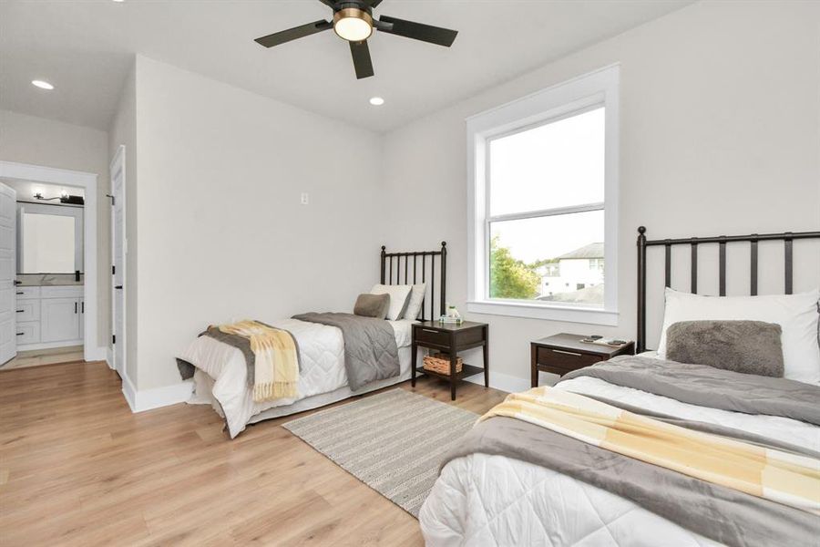 Versatile second primary room or kids' space with ample room for two and delightful natural light.