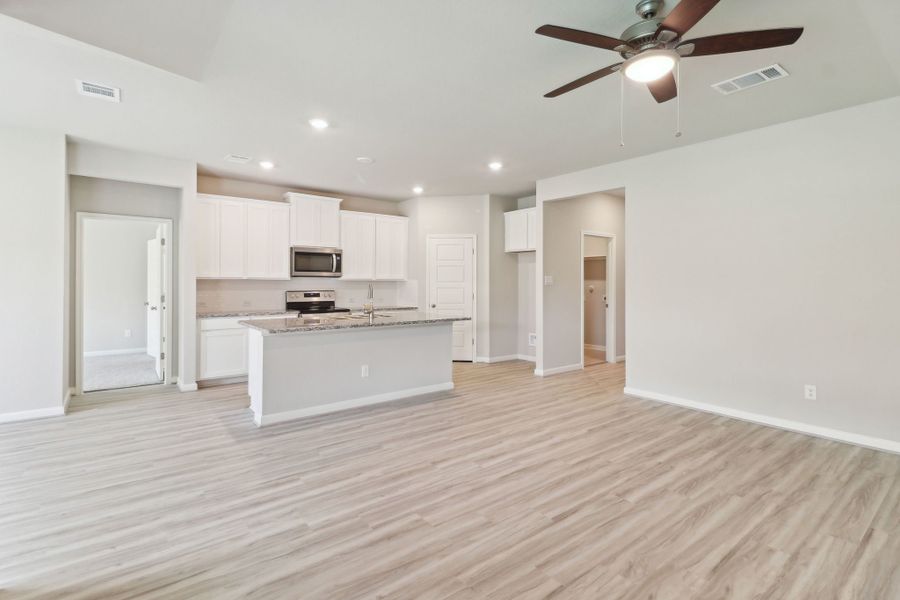 Kitchen and living room in the Callaghan floorplan at a Meritage Homes community.