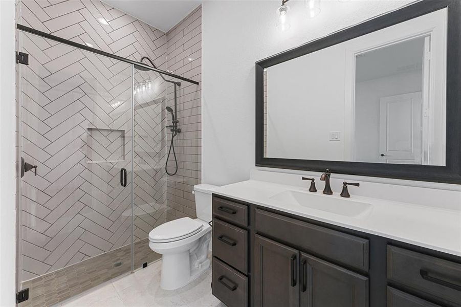 This Jack and Jill bathroom is a blend of style and functionality, featuring a sleek walk-in shower that’s both modern and spacious. Perfectly situated between two bedrooms, it offers convenience and privacy.