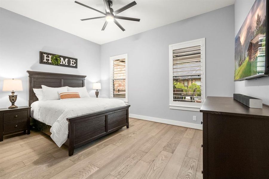 Third bedroom overlooks beautiful backyard and includes hardwood floors, plantation shutters, built-in cabinetry in the closet and 5" baseboards