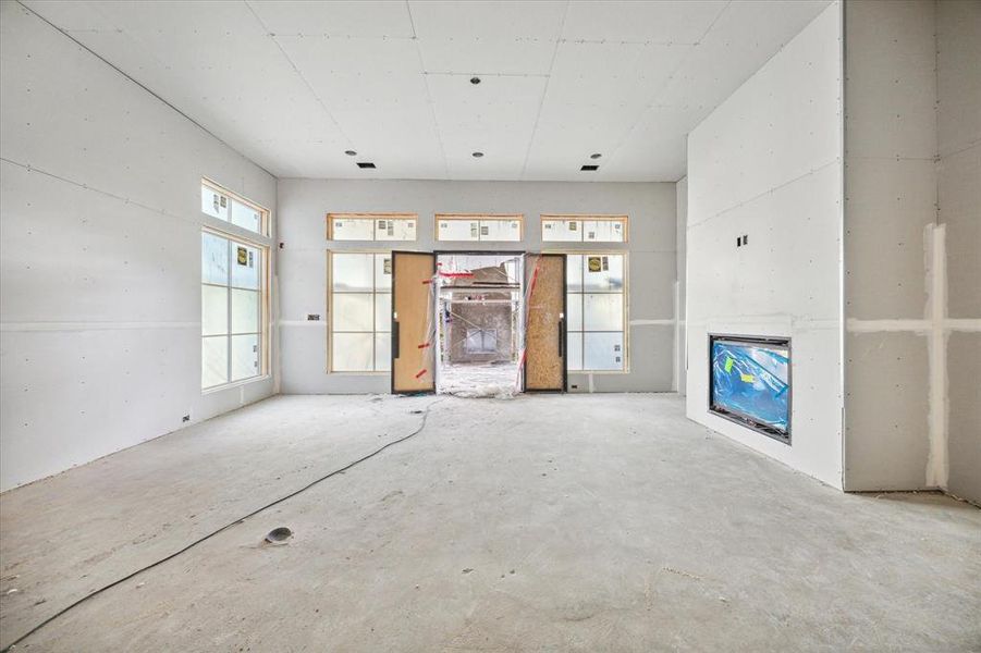 View toward the back covered patio complete with gas log fireplace.   Construction as of 10/29