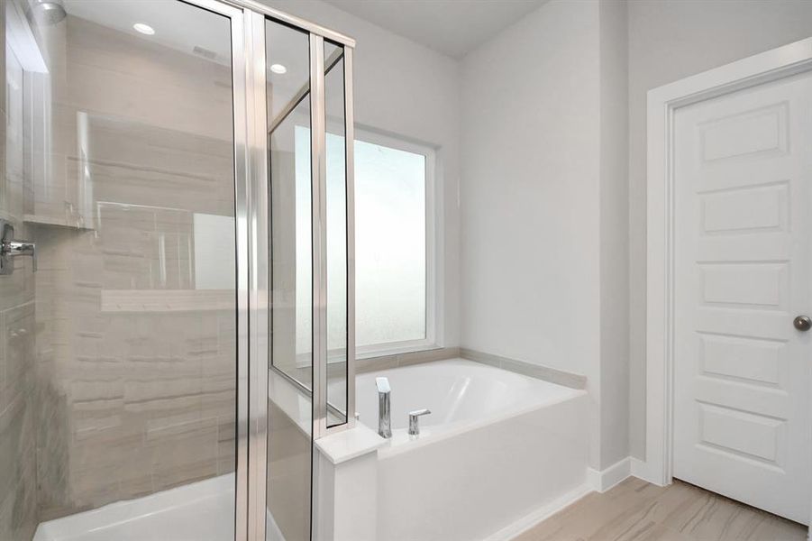 The primary en-suite has a soaking tub to give you that spa experience. The large privacy window allow lots of nature light in the space.