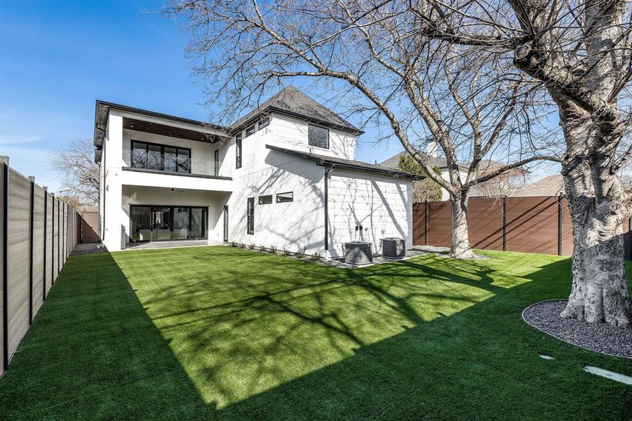 Back of house with a lawn, a patio, and central air condition unit