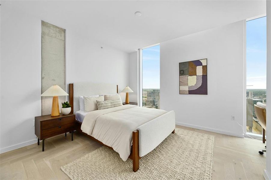 The third bedroom is spacious, featuring white-painted walls and light brown wood tile flooring, enhancing its bright and serene ambiance. *Linden Residence No. 2107 Furnished Model Shown Here