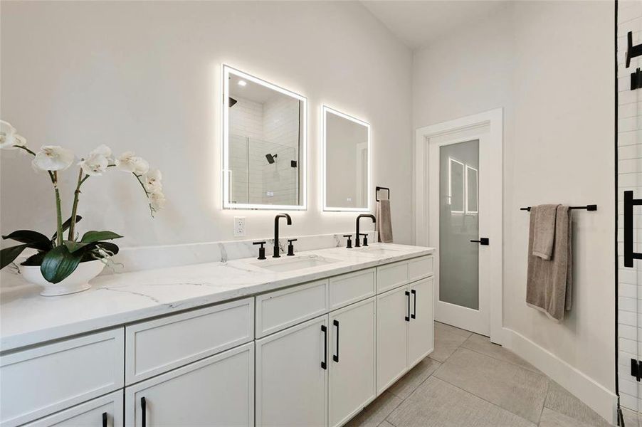 The master bath is elegantly appointed with sleek cabinets, offering both style and functionality. The dual vanity provides ample storage space for your essentials.