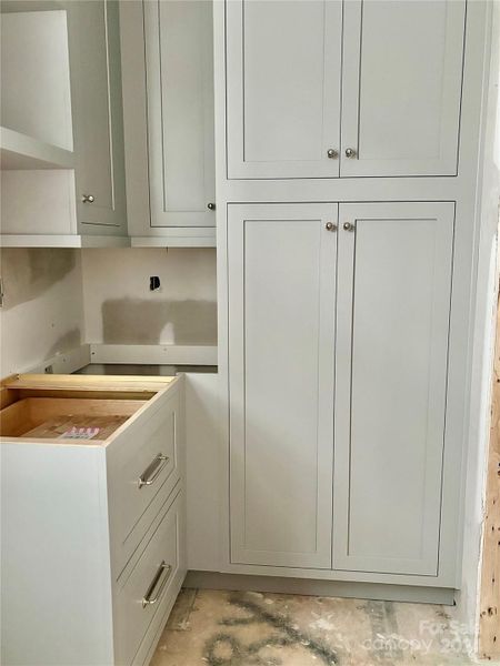 Interior View of Scullery w/ pantry shelving on both ends