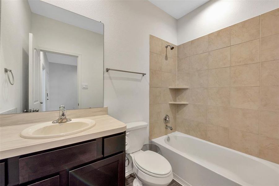 The full bath on the first floor has a tub and shower. The vanity has lots of room for storing all your bath needs.