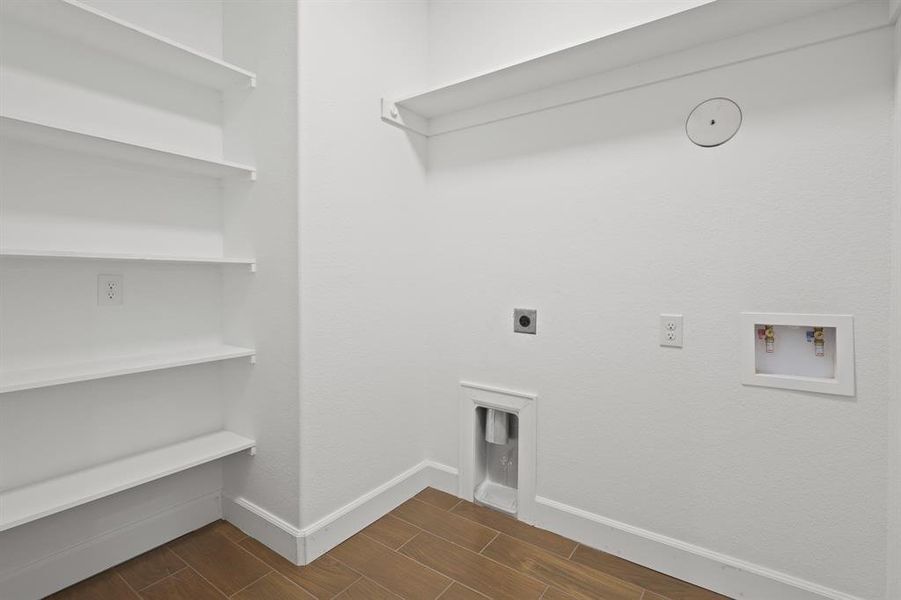 Clothes washing area featuring electric dryer hookup and washer hookup