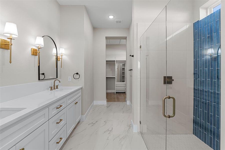 Bathroom with vanity and a shower with door