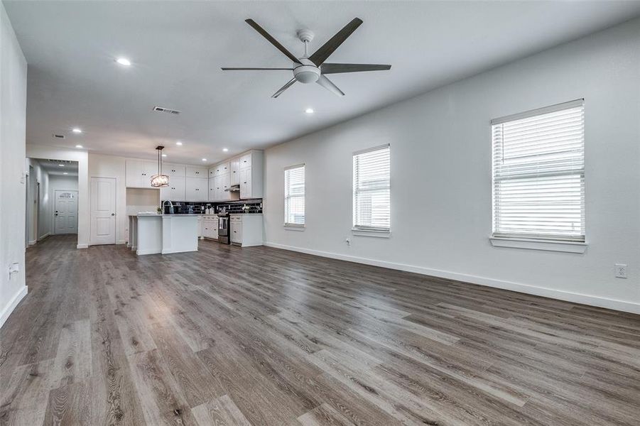 Unfurnished living room featuring light hardwood / wood-style floors and ceiling fan