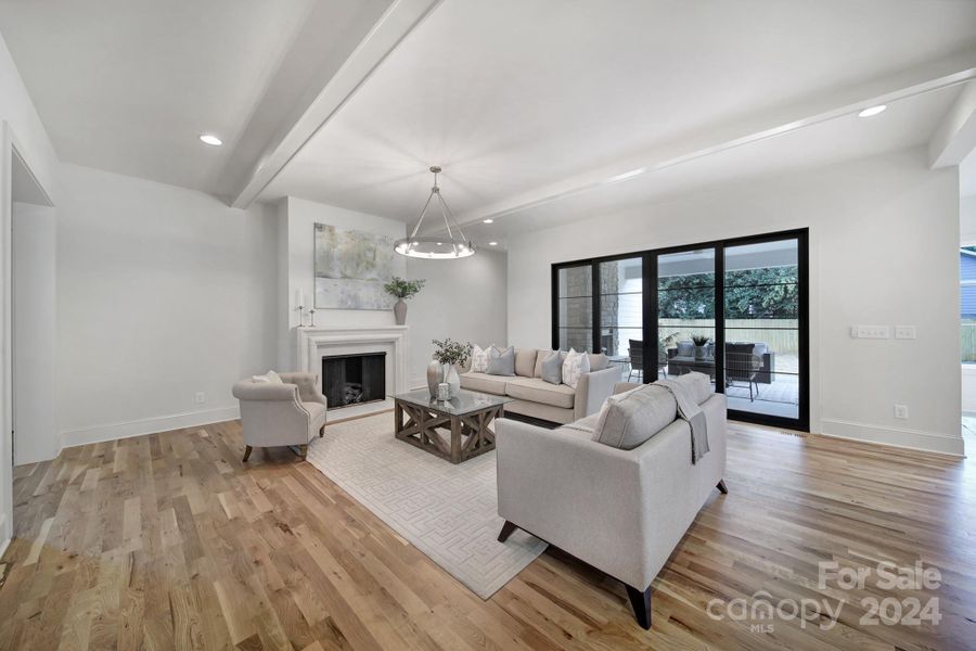 Large living room overlooks the covered back patio and into the backyard.