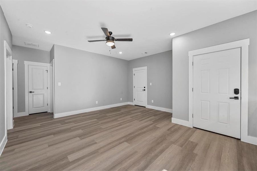 Empty room featuring light hardwood / wood-style floors and ceiling fan