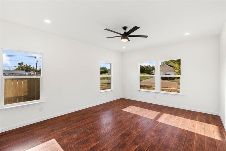 Unfurnished room featuring ceiling fan and hardwood / wood-style flooring