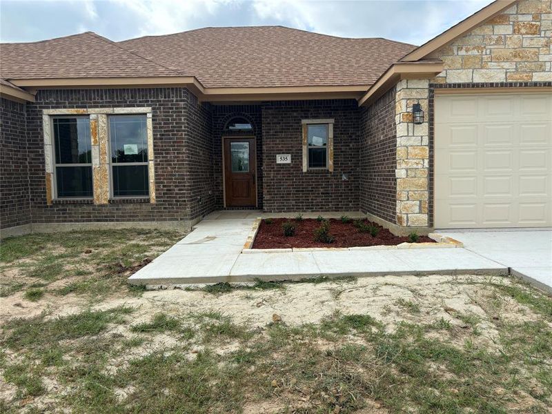 Covered front porch with upgraded front door.