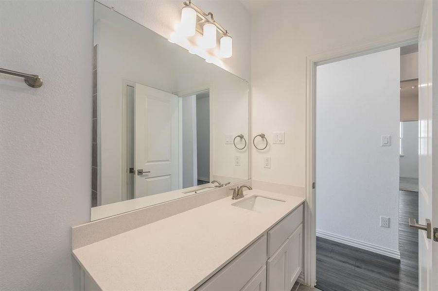 Bathroom featuring vanity and hardwood / wood-style floors