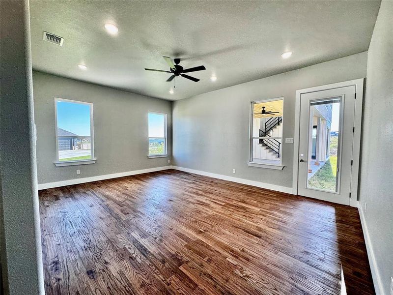 Unfurnished room featuring ceiling fan, a textured ceiling, and hardwood / wood-style floors