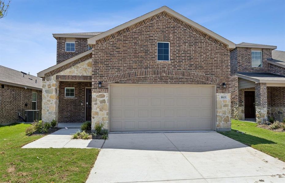 NEW CONSTRUCTION: Beautiful two-story home available at Travis Ranch in Forney