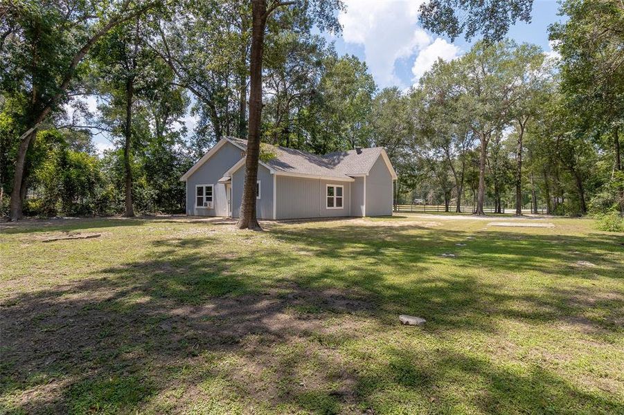 Nestled among mature trees, offering a spacious yard and a serene, natural setting.