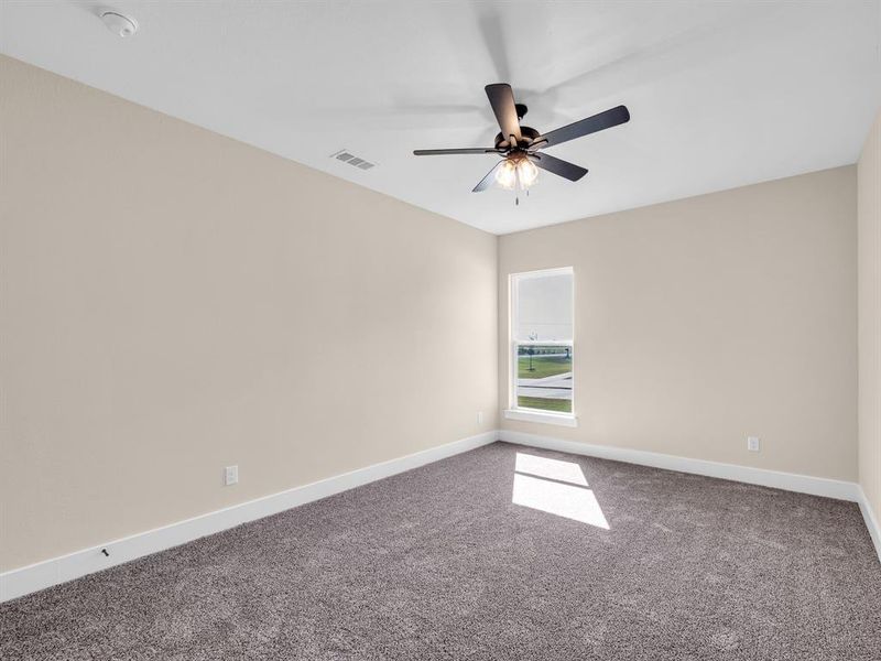 Carpeted spare room with ceiling fan