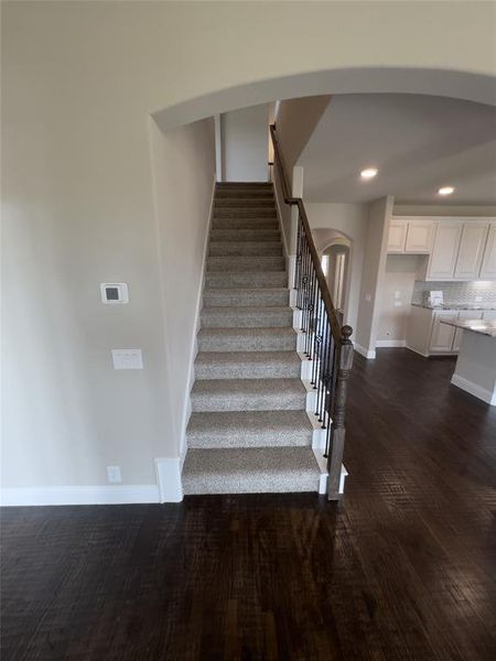 Stairs featuring hardwood / wood-style floors