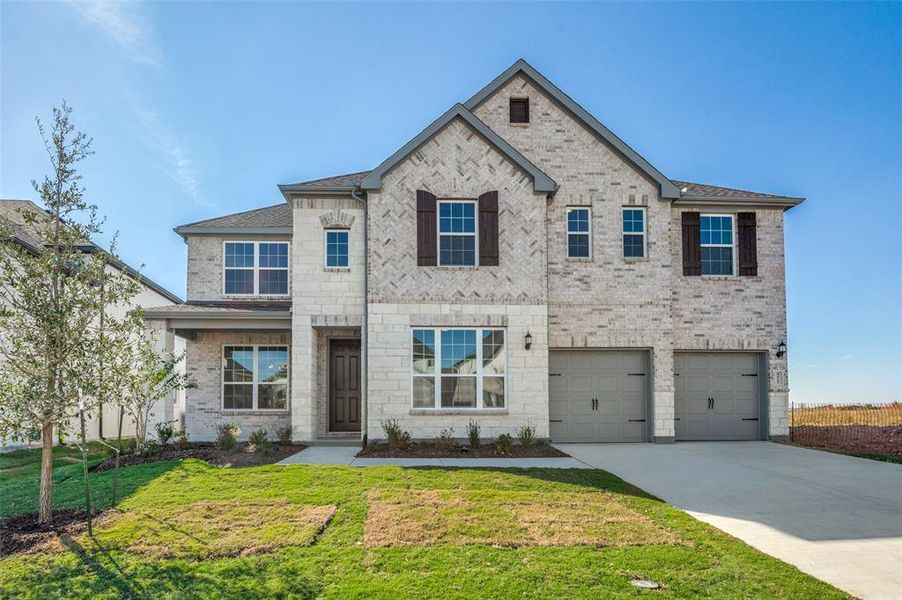 View of front of property with a front lawn and a garage