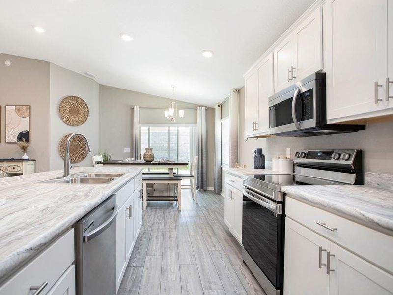 Spacious kitchen with walk-in pantry and breakfast bar - Parsyn home plan by Highland Homes