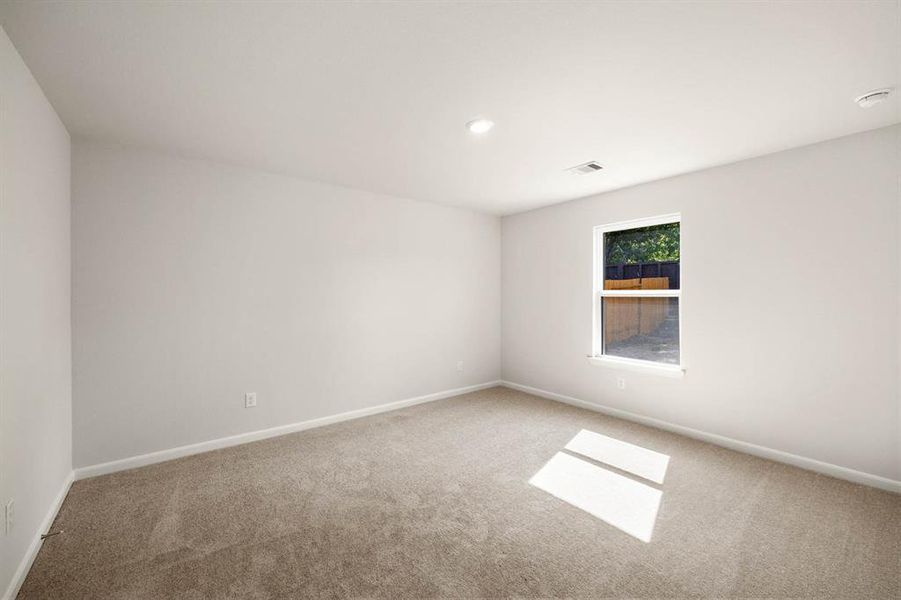 The primary bedroom is the perfect place to relax after a long day.