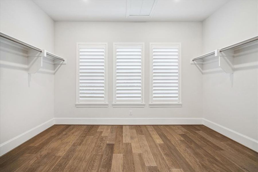 Just beyond the Primary Ensuite is the main walk-in closet (there is an additional closet not pictured) with perfect natural light and ample space to curate a beautiful dressing room.