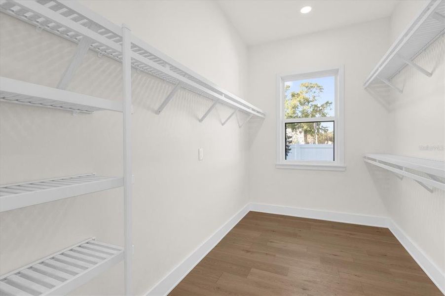 Large primary closet with shelving in place