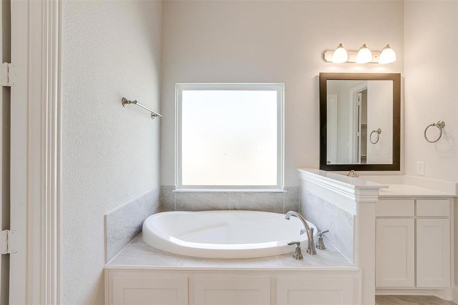 Bathroom featuring a bathtub and vanity