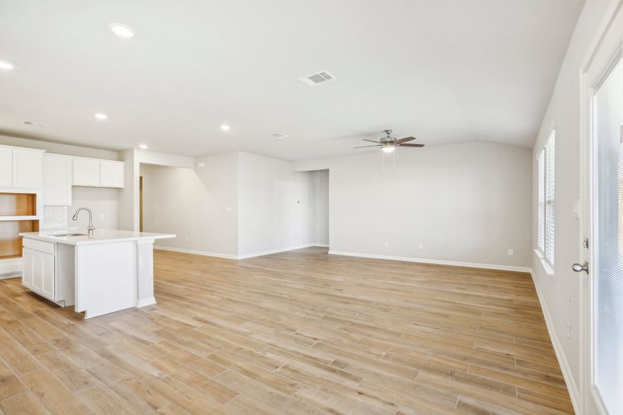 Dining room and living room in the Fitzhugh floorplan at a Meritage homes community.