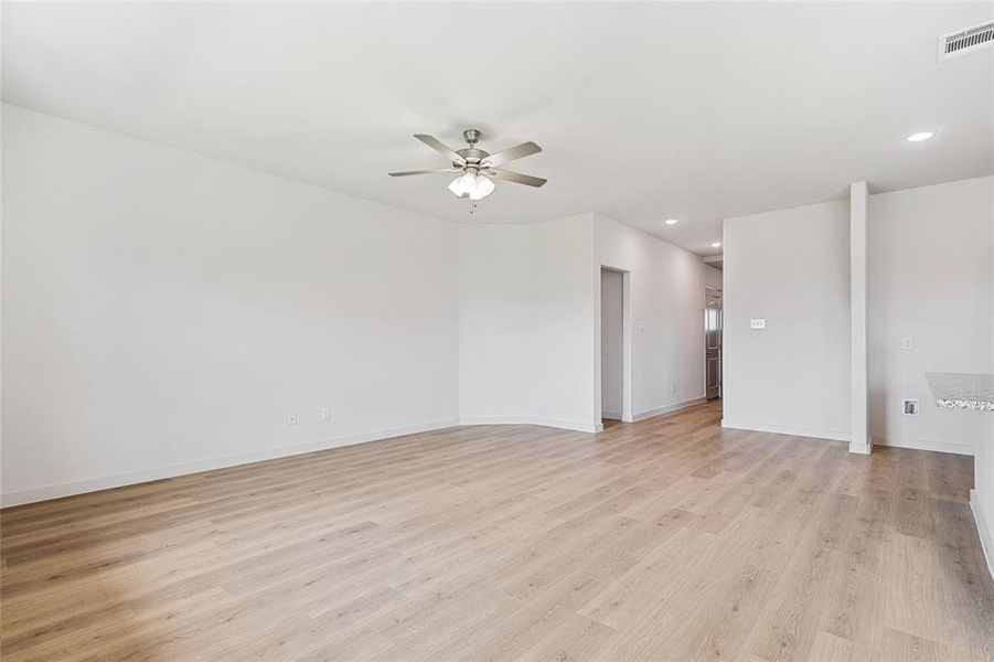 Spare room featuring ceiling fan and light wood-type flooring