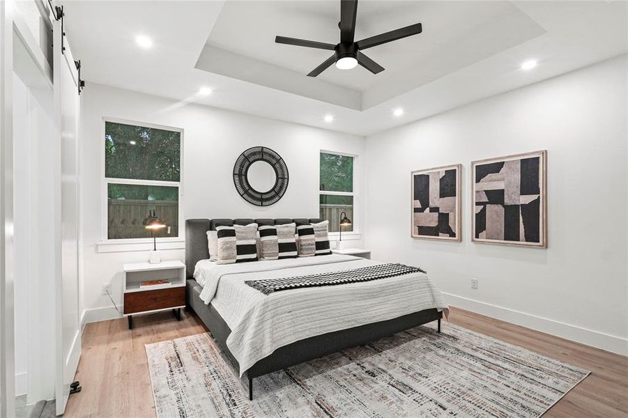 Kitchen with white cabinets, a premium fireplace, sink, a kitchen island with sink, and pendant lighting