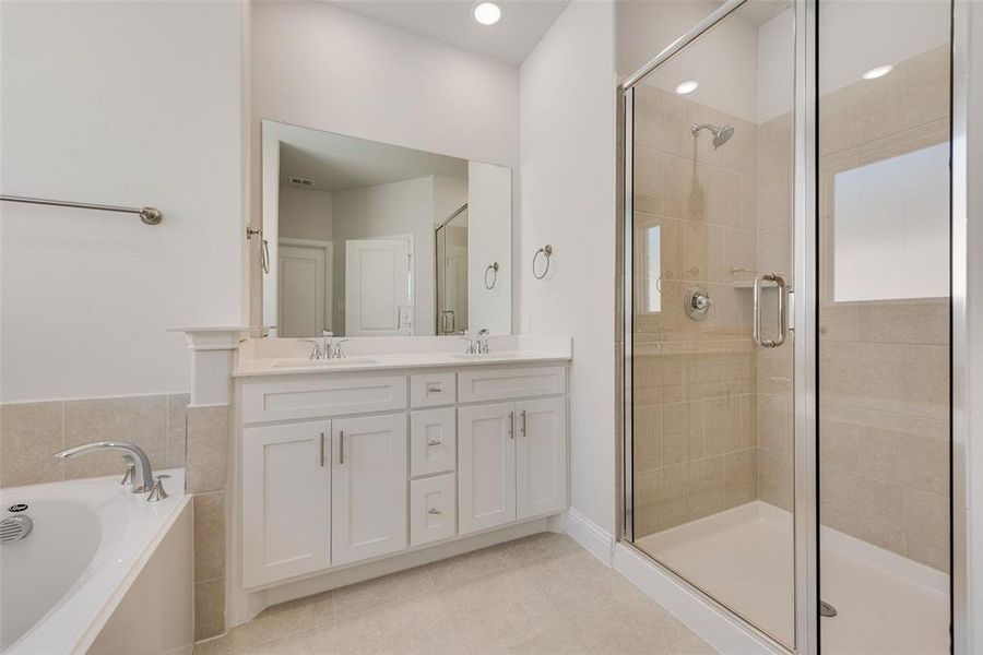 Bathroom with vanity, separate shower and tub, and tile patterned flooring