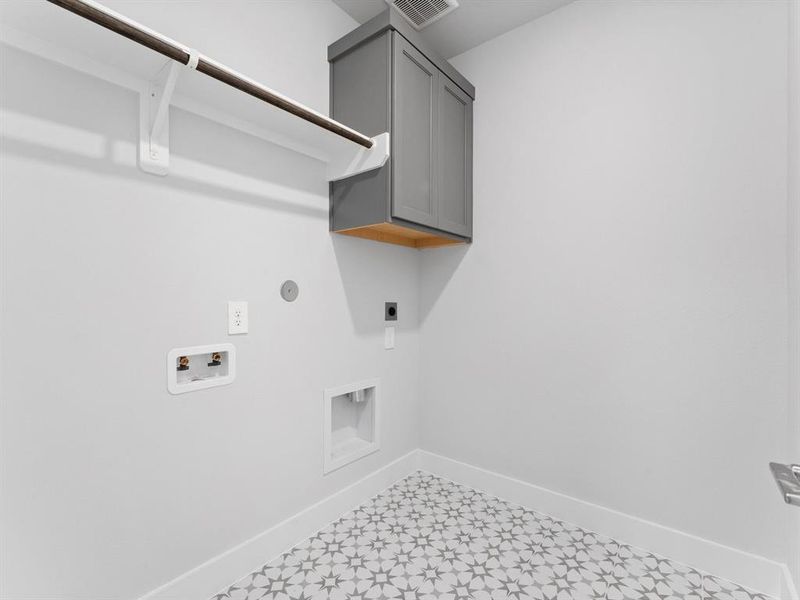 Utility Room with Tile Flooring, Washer and Dryer Connections, Hanging Bar, and Storage Cabinet