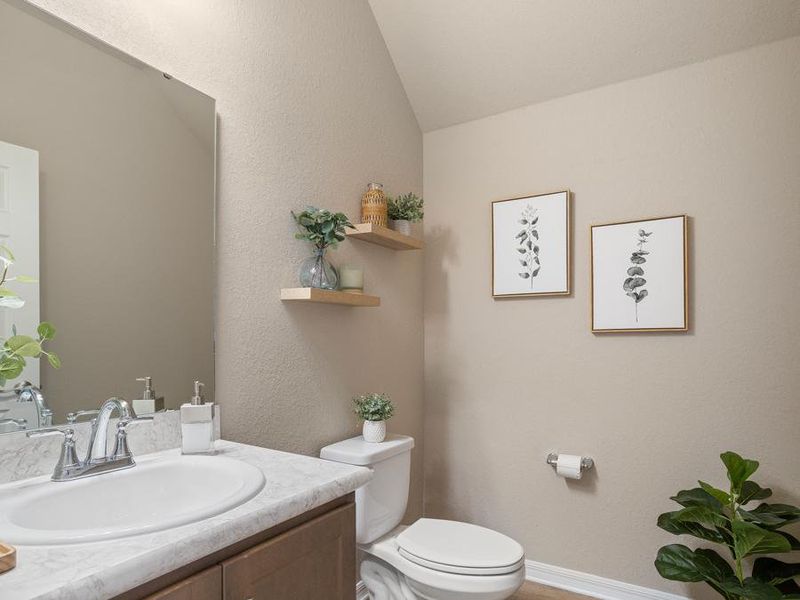 Convenient downstairs powder room perfect for guests - Mariposa townhome by Highland Homes