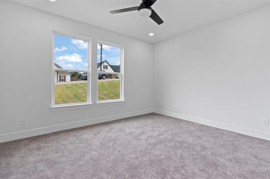 Empty room with carpet floors and ceiling fan