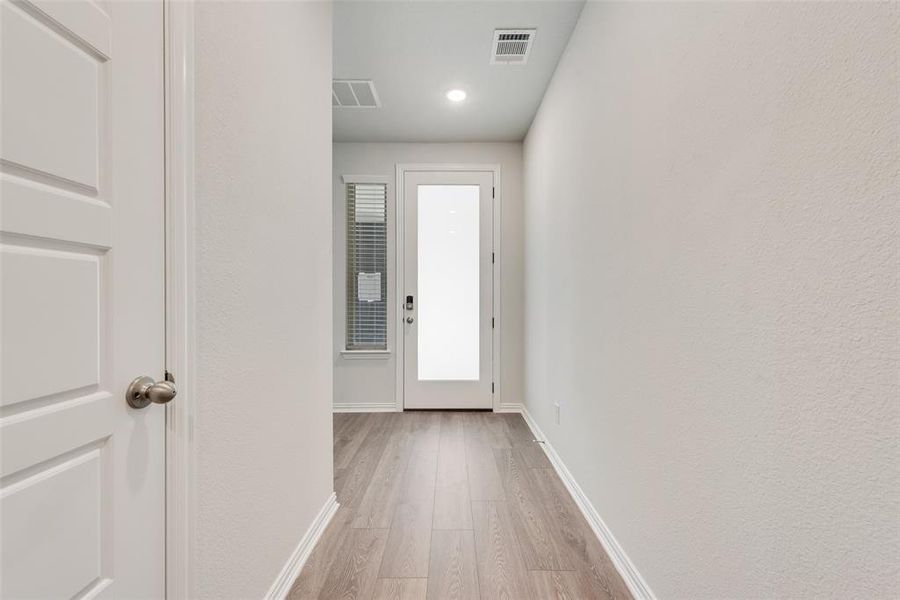 Doorway with light hardwood / wood-style flooring