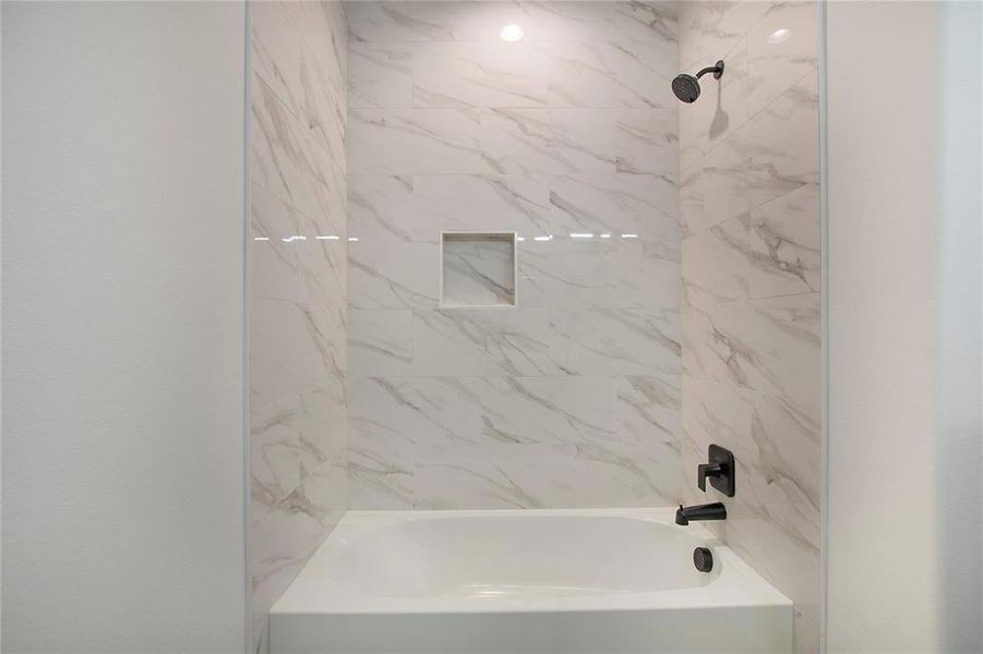 Bathroom featuring tiled shower / bath